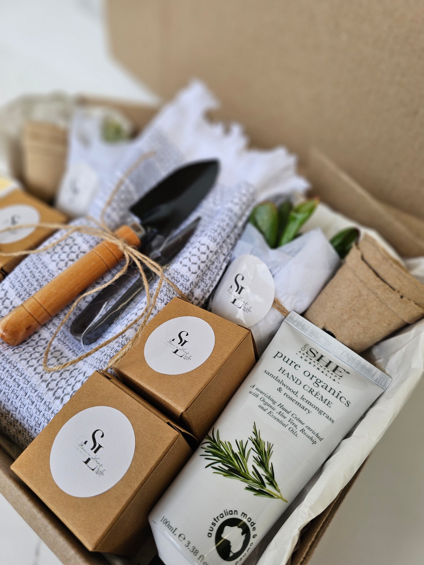 Garden-themed gift set with tools and products in a box