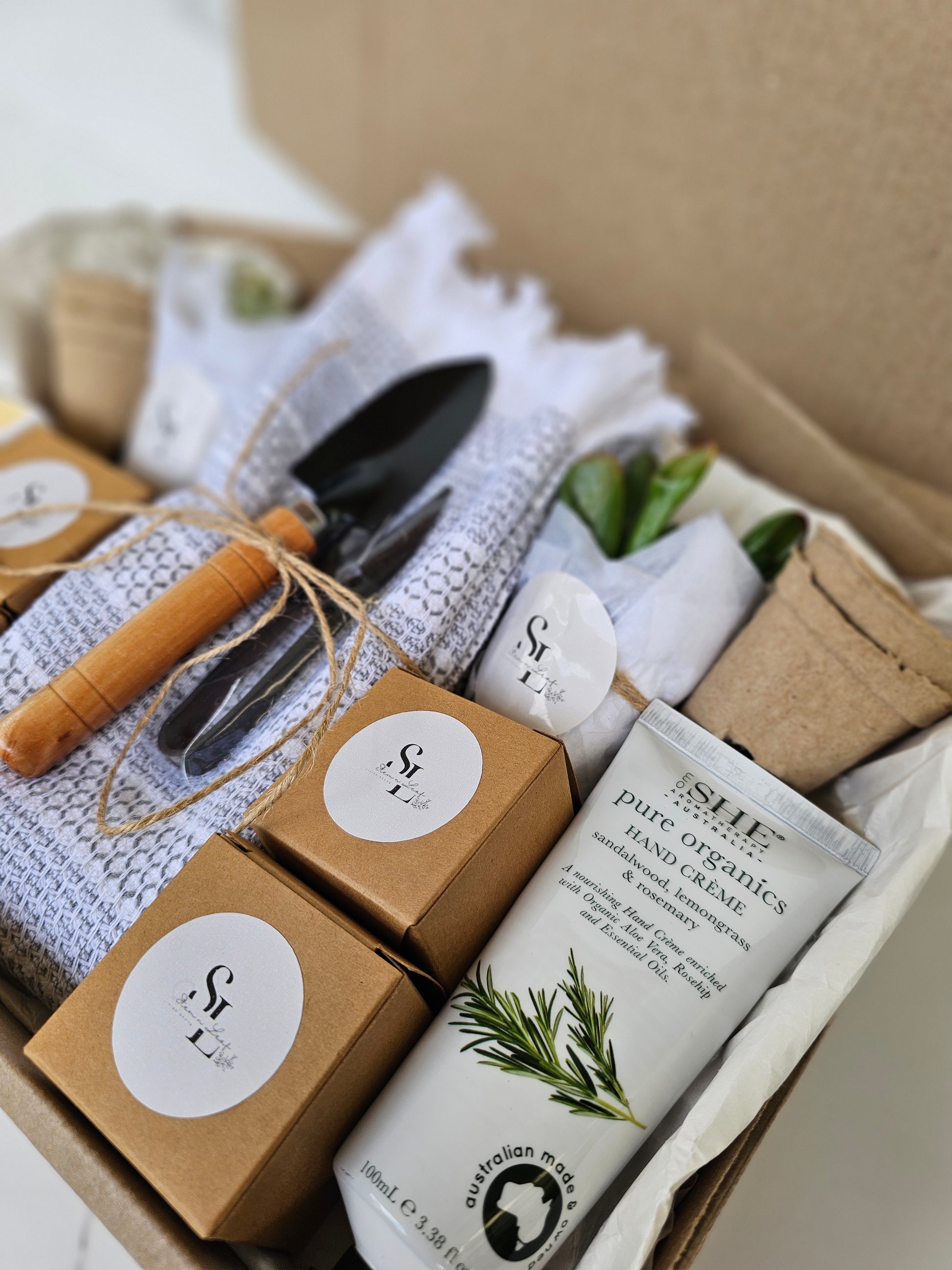Garden-themed gift set with tools and products in a box