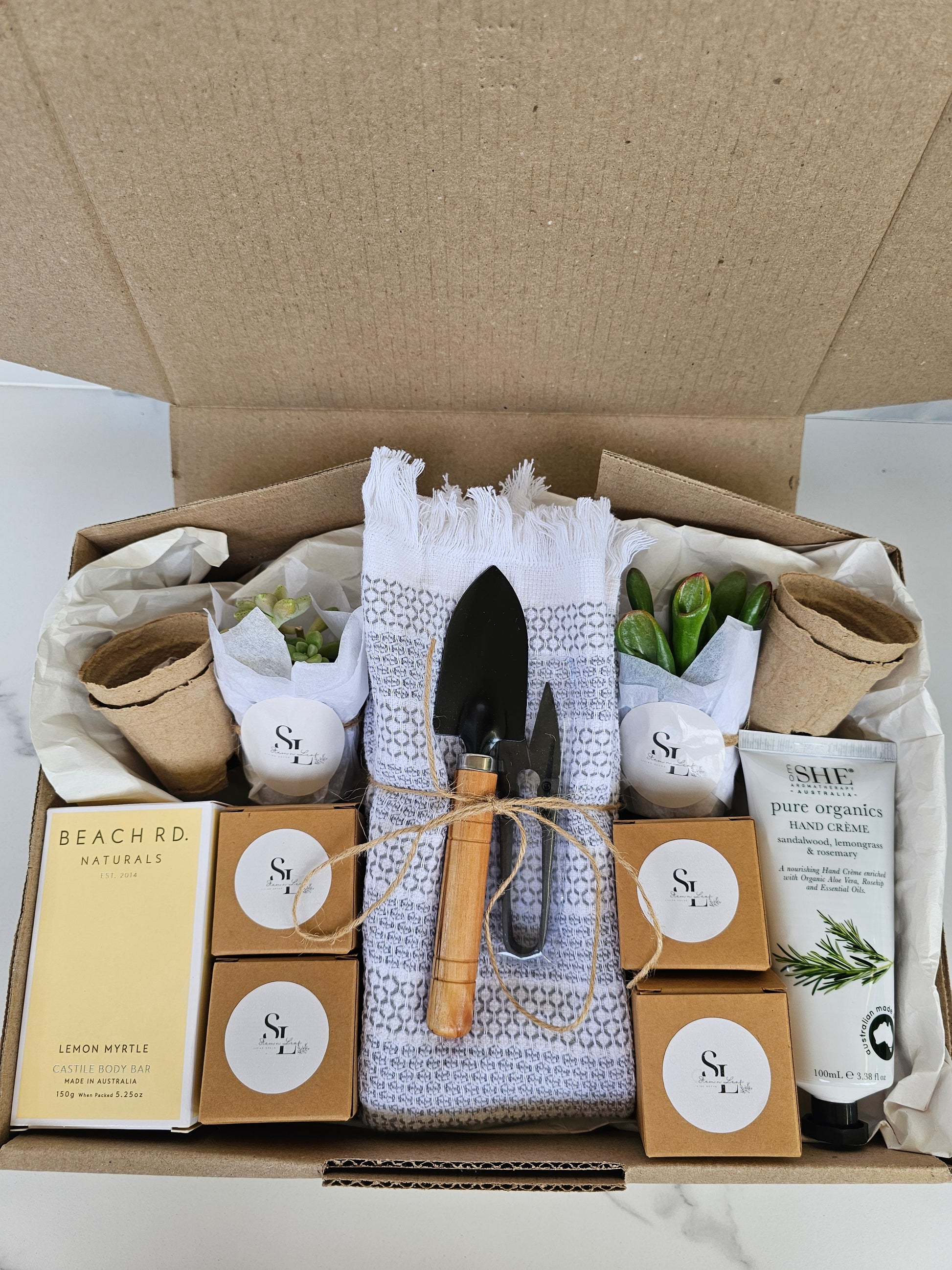 Garden-themed gift set with tools and plants in a box